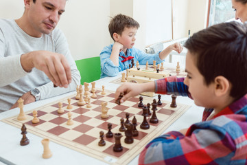 People in chess school learning the game - obrazy, fototapety, plakaty
