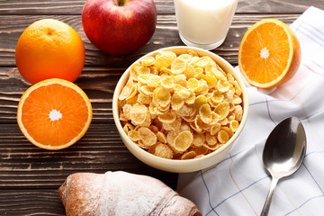 Cornflakes on a wooden table. Healthy Breakfast with vitamins. Place for text. Top view