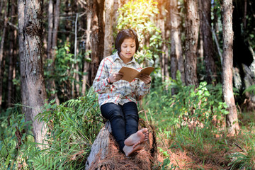 asian student girl reading a book nature forest background