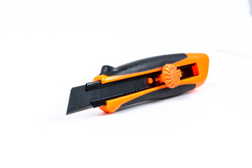 Orange and back paper knife or cutter on white background