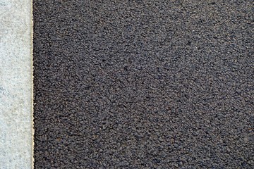 Close up alphalt surface with a white line of a city street for background backdrop 
