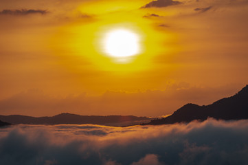 Beautiful dramatic sunset in the mountains. Landscape lot of fog Phu Thok Mountain at Chiang Khan ,Loei Province in Thailand.