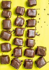 Cookies in chocolate icing on a yellow background. 