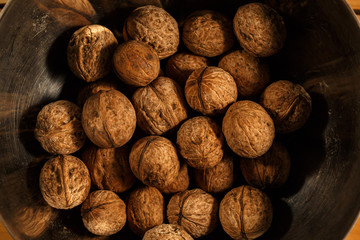 Natural wild walnuts on a natural wooden background
