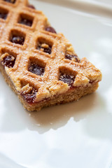 Linzer Torte is traditional Austrian cake with a lattice design on top of the pastry. Filled with jam.