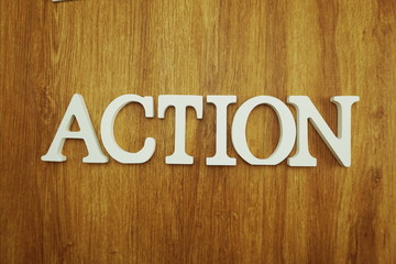 Action word alphabet letters on wooden background