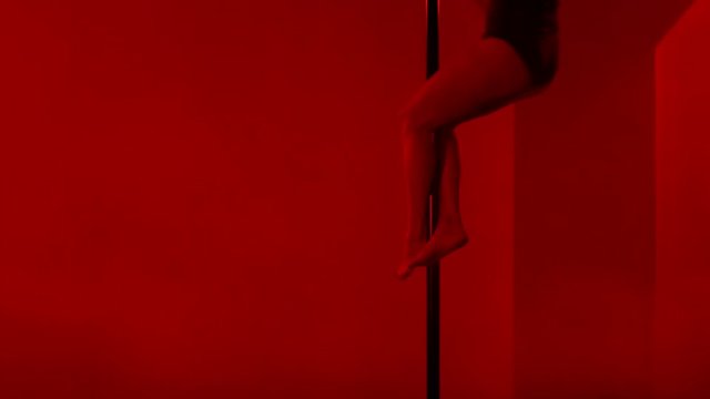 Adult sexy woman dancing dance in an intimate setting. Silhouette of a sexy woman dancing on red background. Pole dance from an old woman