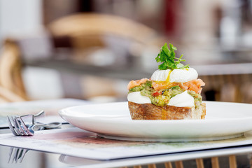 Toast with guacamole, salmon and poached egg.