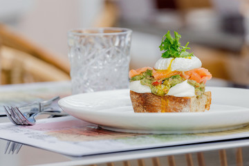 Toast with guacamole, salmon and poached egg.