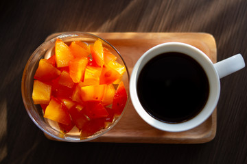 cup of coffee and fresh sliced fruit