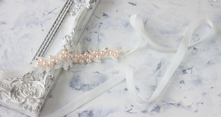 White bow with pearl. Newborn headband on white background.