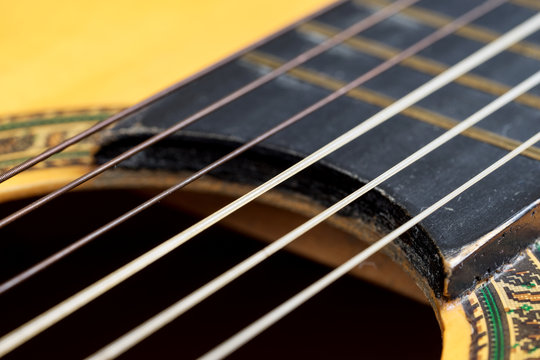 Closeup wooden classical guitar. Old classical guitar with nylon strings. Old acoustic guitar