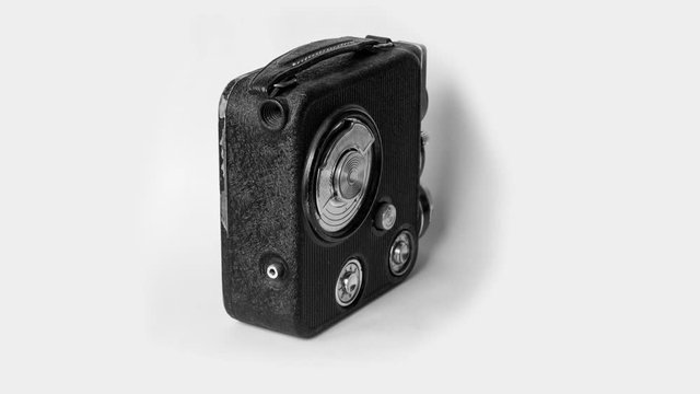 Old vintage movie camera isolated on white background, stop motion animation in 4K resolution.