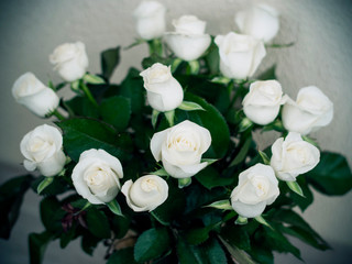 bouquet of white roses on the table in a vase