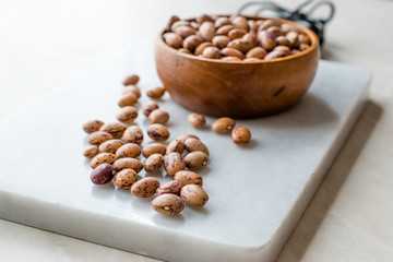 Raw Dry Pinto Beans on Marble Board with Wooden Bowl / Kidney Beans.