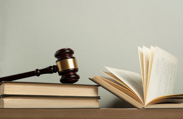 Law concept. Wooden judge gavel with law books on table in a courtroom or enforcement office.