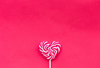 Red valentine day hearth shape lollipop on the red background