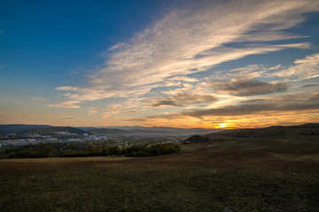 Romantic, bright and colorful sunset over a mountain range in Transylvania. Beautiful, colorful autumn background.  