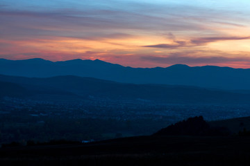 Romantic, bright and colorful sunset over a mountain range in Transylvania. Beautiful, colorful autumn background.  