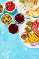 Italian antipasti wine snacks set. Brushettas on blue background.