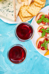 Italian antipasti wine snacks set. Brushettas on blue background.