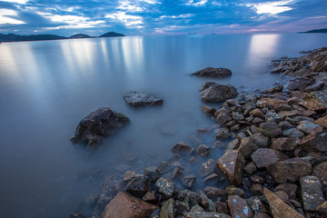 An abstract background of water that is moving or calm along the beach along the rocks of various sizes, natural wallpapers by the lake, looking at one type of natural art without being manipulated.