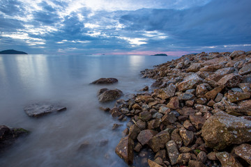 An abstract background of water that is moving or calm along the beach along the rocks of various sizes, natural wallpapers by the lake, looking at one type of natural art without being manipulated.