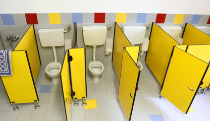 small toilet with yellow doors