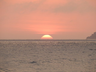 Fototapeta na wymiar Nascer no sol na Praia Brava em Florianópolis, ao fundo a Ilha do Arvoredo.