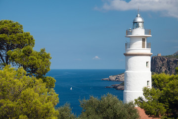 Fototapeta na wymiar Cap Gros lighthouse on hill in Port Soller, Mallorca Island, Spain