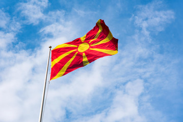 Fototapeta na wymiar Republic of Macedonia flag waving in the sky