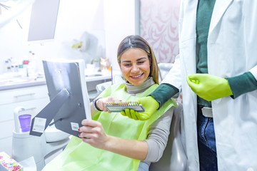 Examining a whiteness of teeth of a patient at the dentist