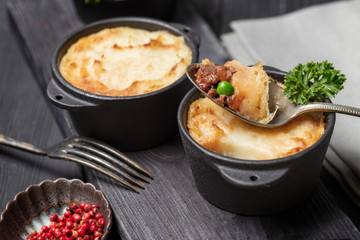 Shepherd's pie, british casserole in cast iron pan, with minced meat, mashed potatoes and...