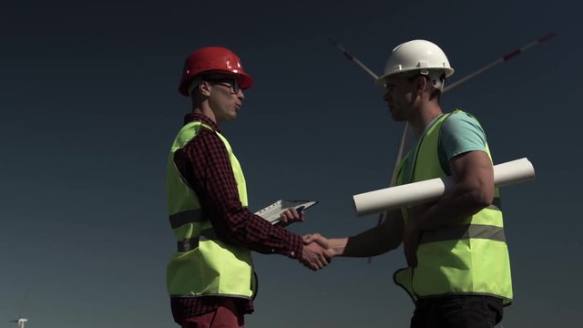 The Male Architect And The Engineer Shake Hands To Each Other Approving A New Joint Project. Concept Of A Greeting Handshake