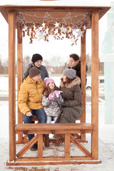 Walk large family in winter ice playground,