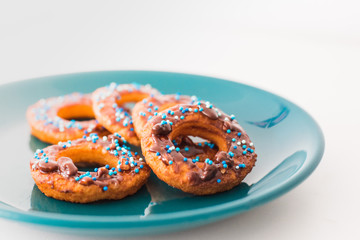 Donut on a plate and on a wooden table.