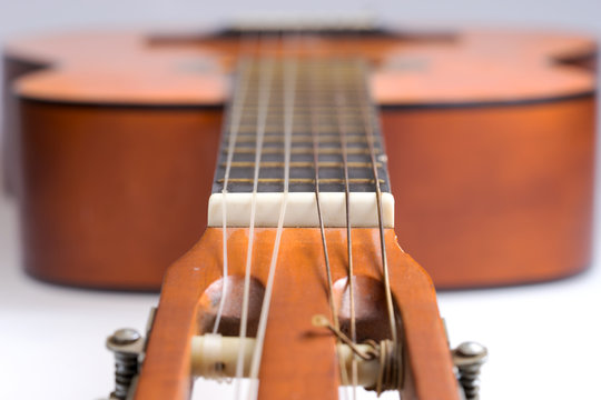 Fretboard of old classical guitar. Stringed musical instrument