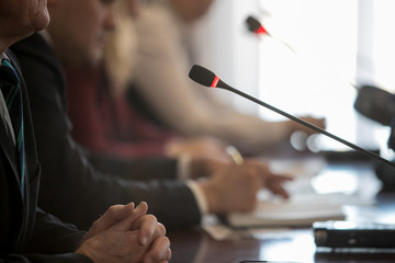Obraz premium Press conference. Public speaker giving talk to Television camera. News conference. An event with a video camera. press and media in public news coverage event for reporter and mass communication