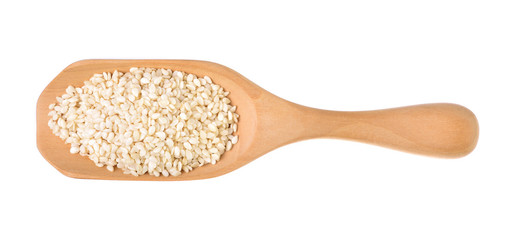 Sesame seeds on a wooden spoon as a white background.