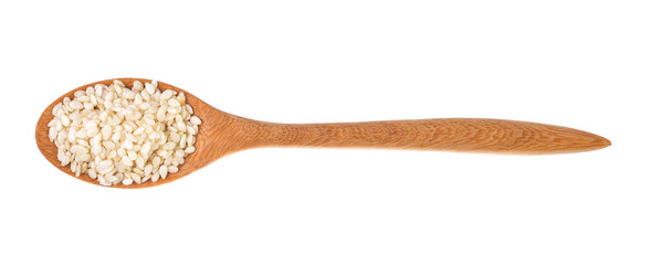 Sesame seeds on a wooden spoon as a white background.