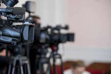 Covering an event with a video camera.