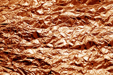 Metal foil texture in orange tone.