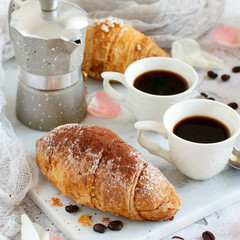 Breakfast with coffee and croissant