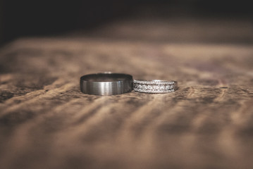silver wedding rings on wooden table