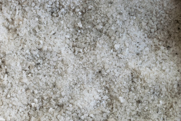 Spilled salt. A lot of stone salt. Sea salt as background and texture