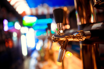 close-up of barman hand at beer tap pouring a draught lager beer - obrazy, fototapety, plakaty