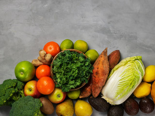 Top view of fresh raw vegetables, fruits on gray background banner. Different varieties of cabbages, chinese cabbage, broccoli, kale. Copy space for text, selective focus.