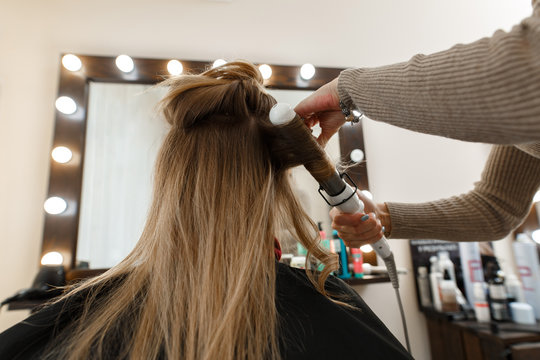 the process of hair styling in the hairdressing salon.
studying hairdressing.
Professional hairdresser working with client in salon.
the process of creating an evening hairstyle 