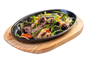 Hot frying pan with veal, chinese mushrooms and vegetables.