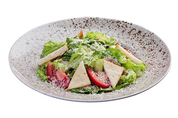 Caesar salad with chicken breast and anchovy sauce. On white background